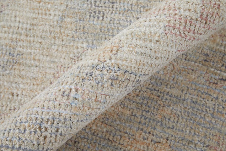 4' X 6' Ivory Tan and Blue Floral Hand Woven Distressed Area Rug With Fringe