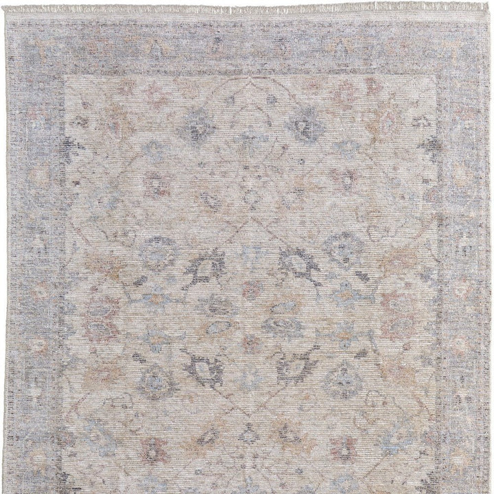 4' X 6' Ivory Tan and Blue Floral Hand Woven Distressed Area Rug With Fringe