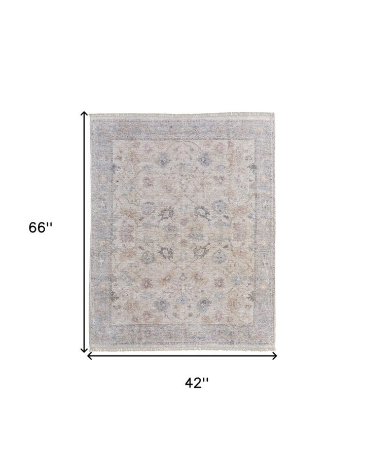 4' X 6' Ivory Tan and Blue Floral Hand Woven Distressed Area Rug With Fringe