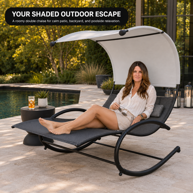 Woman relaxing on a navy chaise lounger with canopy shade beside a pool