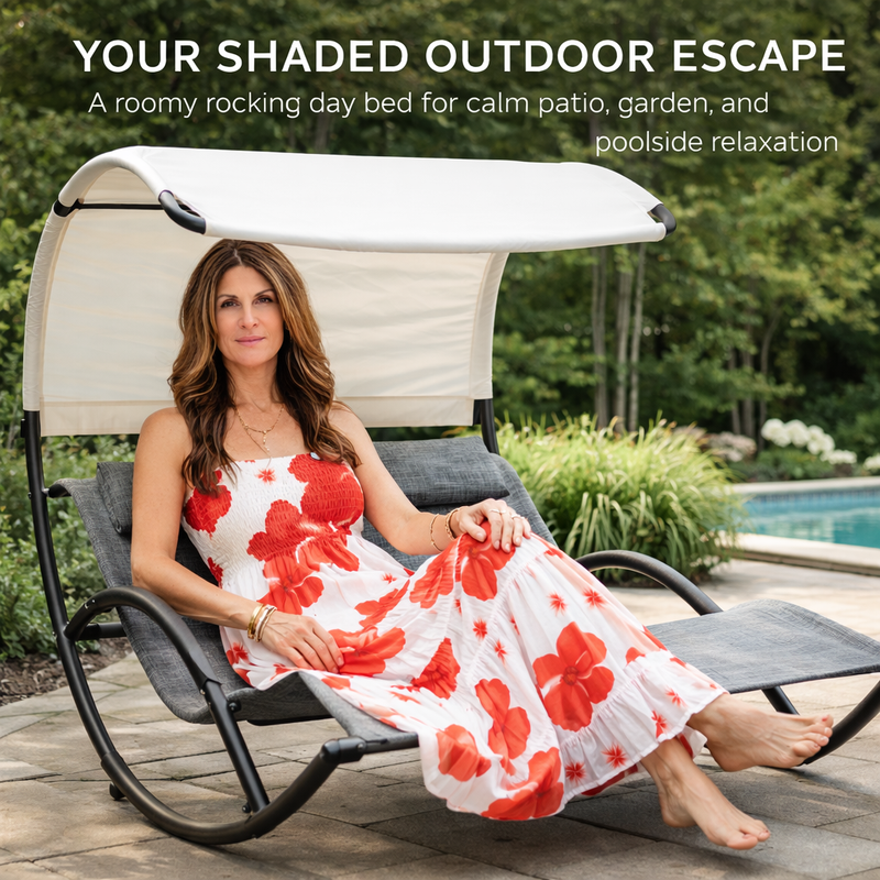 Woman relaxing on a navy chaise lounger with canopy shade beside a pool