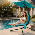 Woman relaxing on a navy chaise lounger with canopy shade beside a pool