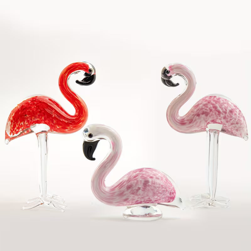 Hand-blown pink glass flamingo figurine with curved neck in sitting pose