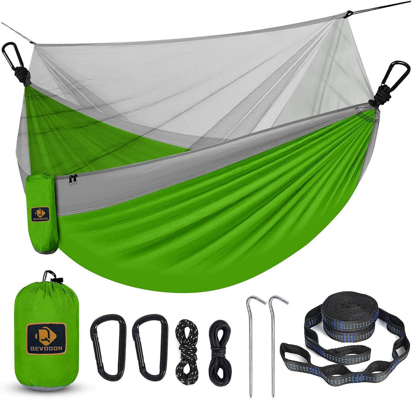 Hammock with mosquito net shown with a carry bag - carabiners - elastic ropes - sand pegs and tree straps