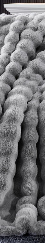 White faux fur heated blanket with its controller draped over a grey sectional sofa - Throw (50”x60”) / Light      Grey