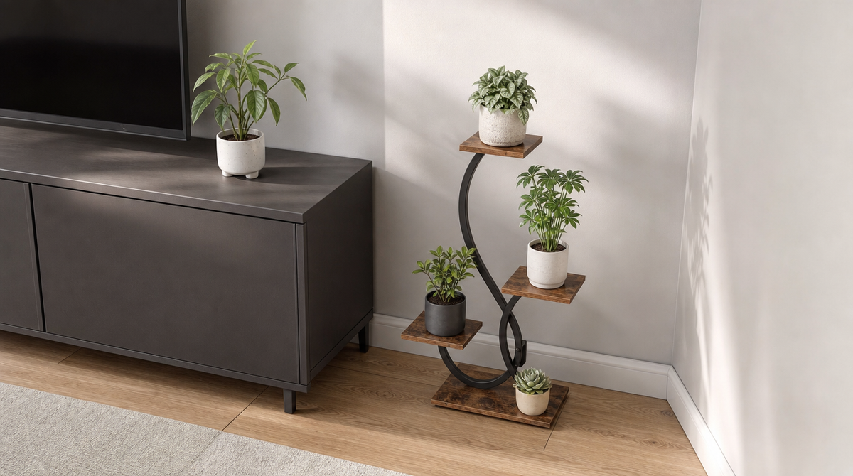 “Compact four-tier plant stand with brown shelves and a black S-shaped frame tucked beside a TV cabinet.”