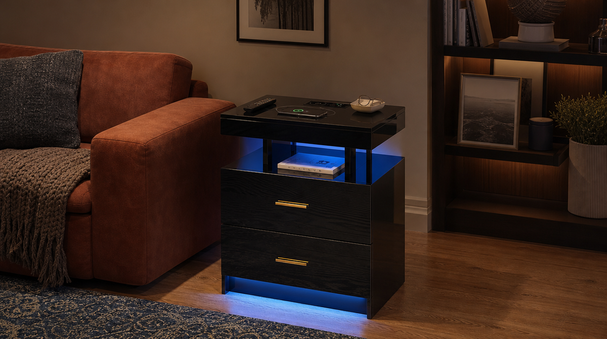 “Black two-drawer LED nightstand used as a side table beside a rust-colored sofa, holding a phone, remote, and books.”
