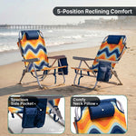 Two reclining backpack beach chairs on the beach highlighting the 5-position recline, the side storage pocket holding keys and a phone, and the padded neck pillow