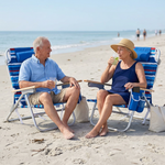 Two people relaxing in matching light blue stripe backpack beach chairs on the sand, each reclined with a drink in hand and the ocean in the background