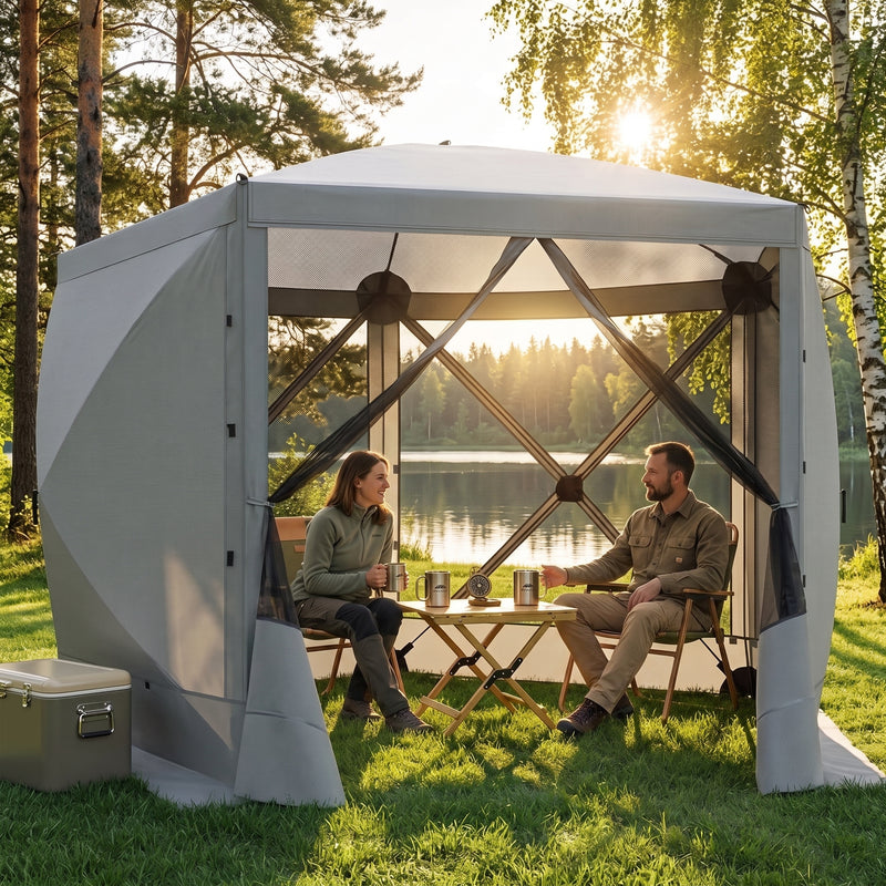 Brown pop-up screen gazebo at a forest lakeside campsite with two people seated at a table inside
