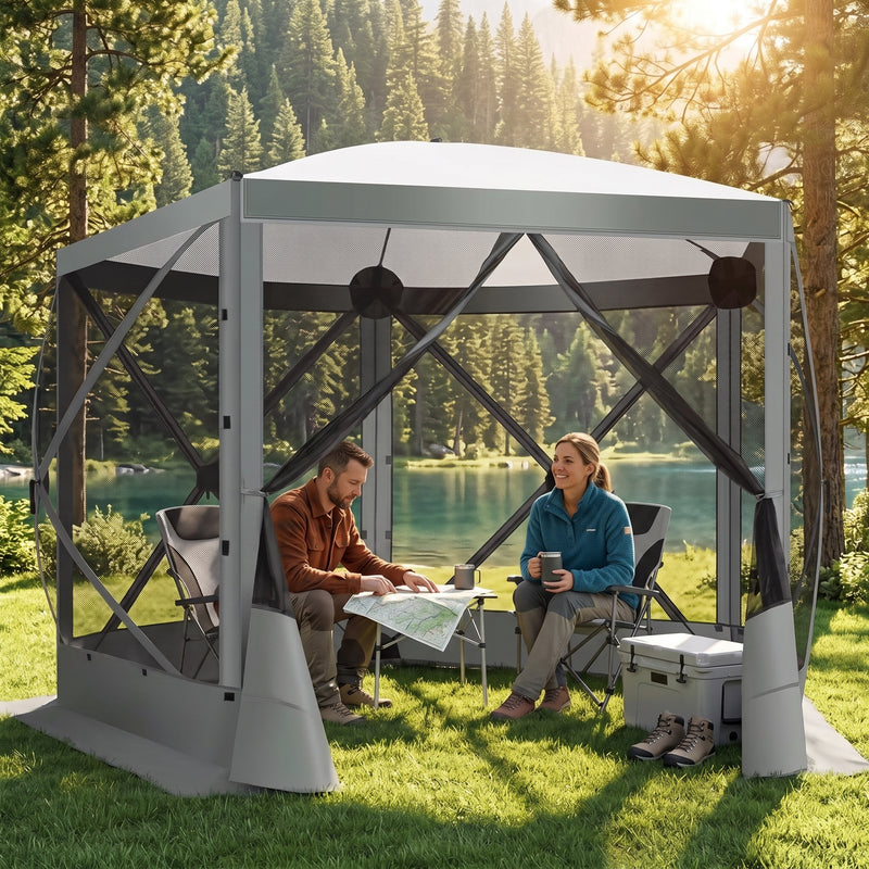 Brown pop-up screen gazebo at a forest lakeside campsite with two people seated at a table inside