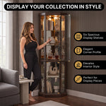 Person arranging décor inside the open glass door of the tall oak corner curio cabinet