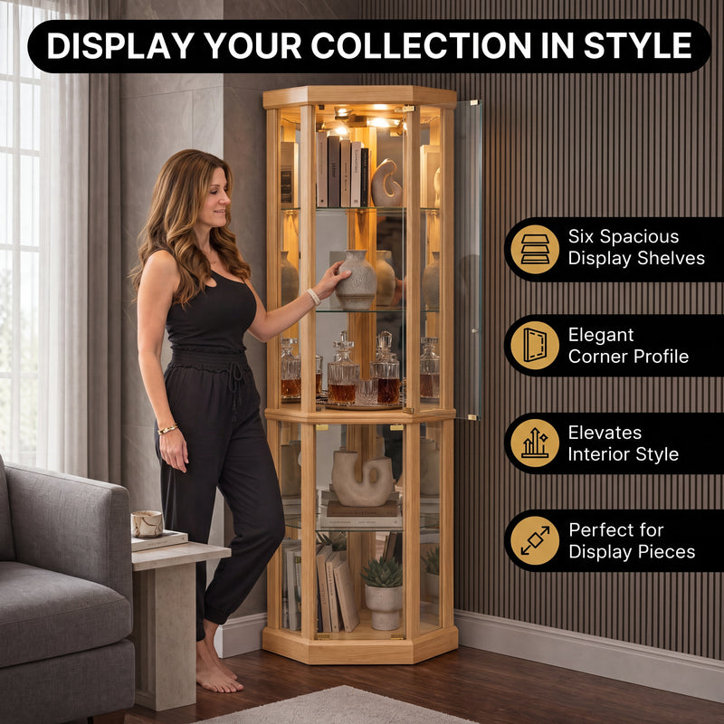 Person arranging décor inside the open glass door of the tall oak corner curio cabinet