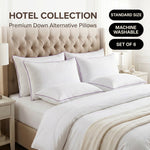 Down alternative pillows stacked on a bed against a gray tufted headboard under a Hotel Collection banner