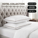 Down alternative pillows stacked on a bed against a gray tufted headboard under a Hotel Collection banner