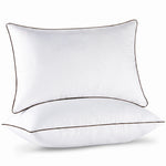 Two down alternative pillows with brown piping and a subtle damask pattern, stacked on a white background