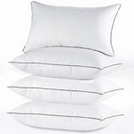 Two down alternative pillows with brown piping and a subtle damask pattern, stacked on a white background