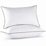 Two down alternative pillows with brown piping and a subtle damask pattern, stacked on a white background
