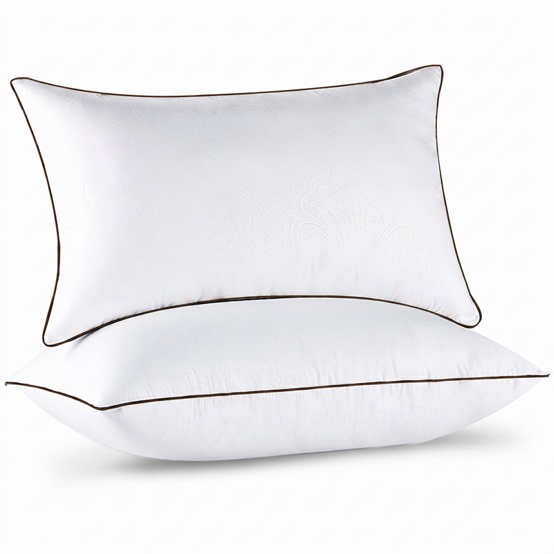 Two down alternative pillows with brown piping and a subtle damask pattern, stacked on a white background