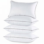 Two down alternative pillows with brown piping and a subtle damask pattern, stacked on a white background