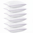 Two down alternative pillows with brown piping and a subtle damask pattern, stacked on a white background