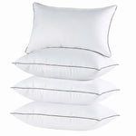 Two down alternative pillows with brown piping and a subtle damask pattern, stacked on a white background