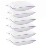 Two down alternative pillows with brown piping and a subtle damask pattern, stacked on a white background
