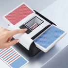 Electric card shuffler in action, shuffling a red and blue deck of playing cards