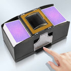 Electric card shuffler in action, shuffling a red and blue deck of playing cards