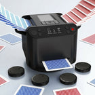 Electric card shuffler in action, shuffling a red and blue deck of playing cards