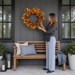 Artificial fall wreath with a measurement line showing a 22-inch diameter when fully extended