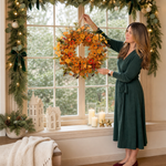 Artificial fall wreath with a measurement line showing a 22-inch diameter when fully extended