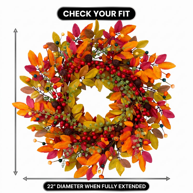 Artificial fall wreath with a measurement line showing a 22-inch diameter when fully extended