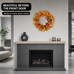 Artificial fall wreath displayed on a front door, porch and above a fireplace