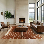 Faux cowhide rug in cow print styled under a leather sofa in a modern living room