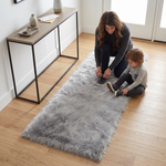 Grey faux fur runner rug styled in an entryway beside a console table on hardwood flooring
