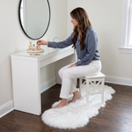 Grey faux fur runner rug styled in an entryway beside a console table on hardwood flooring