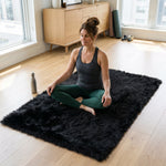 Grey faux fur runner rug styled in an entryway beside a console table on hardwood flooring