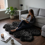 Grey faux fur runner rug styled in an entryway beside a console table on hardwood flooring