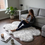 Grey faux fur runner rug styled in an entryway beside a console table on hardwood flooring