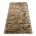 Close-up of grey faux fur area rug showing thick high-pile shaggy texture