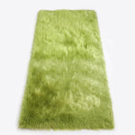 Close-up of grey faux fur area rug showing thick high-pile shaggy texture