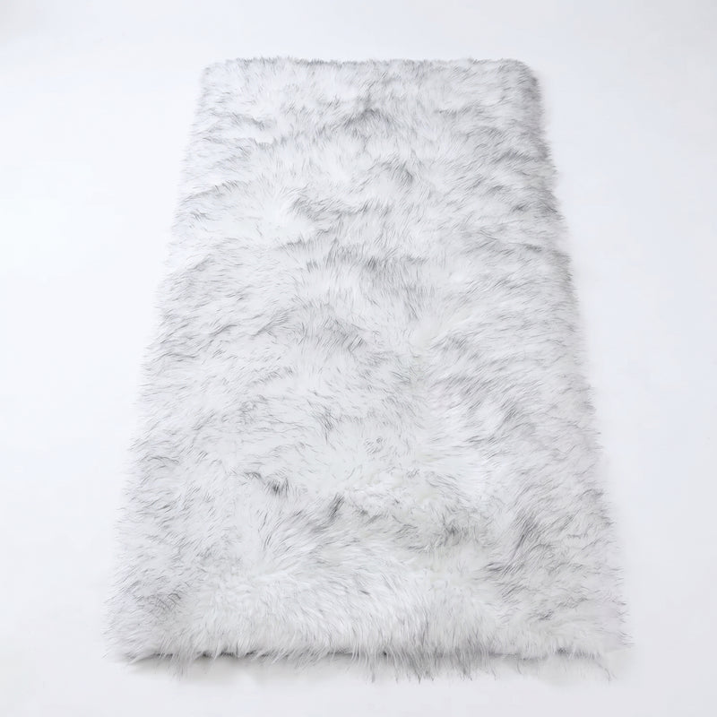 Close-up of grey faux fur area rug showing thick high-pile shaggy texture