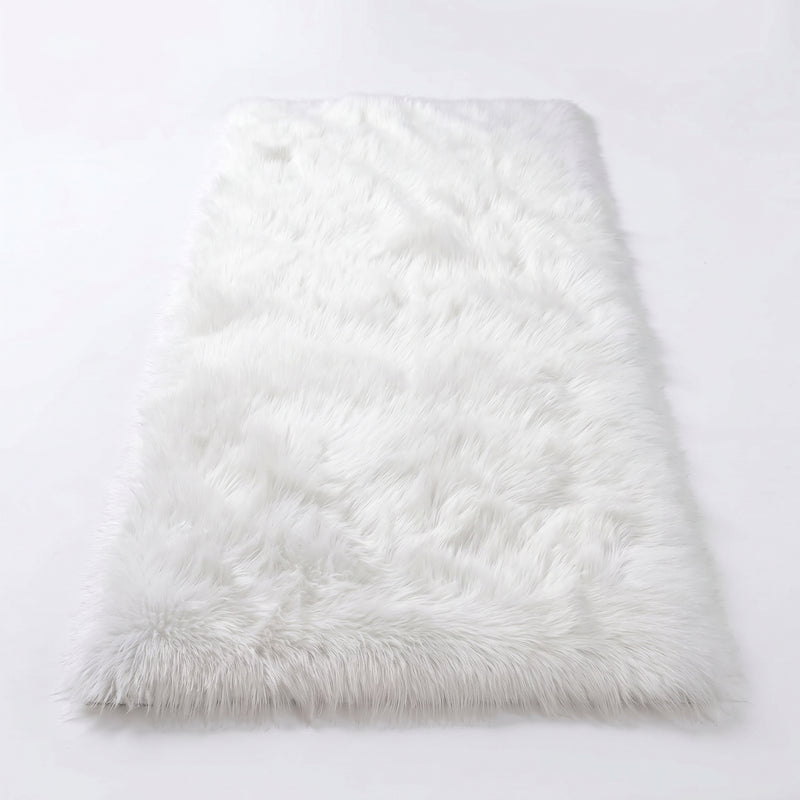 Close-up of grey faux fur area rug showing thick high-pile shaggy texture
