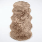 Close-up of grey faux fur area rug showing thick high-pile shaggy texture