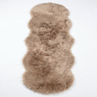 Close-up of grey faux fur area rug showing thick high-pile shaggy texture
