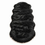 Close-up of grey faux fur area rug showing thick high-pile shaggy texture