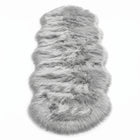 Close-up of grey faux fur area rug showing thick high-pile shaggy texture