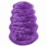 Close-up of grey faux fur area rug showing thick high-pile shaggy texture
