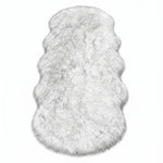 Close-up of grey faux fur area rug showing thick high-pile shaggy texture
